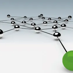 Interconnected silver balls with prominent green ball