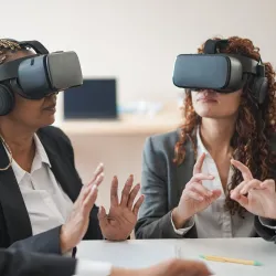 2 women executives wearing VR headsets