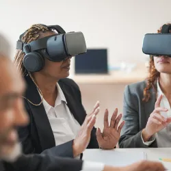female executives wearing virtual reality headsets