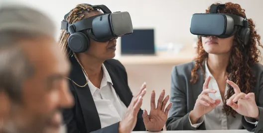 female executives wearing virtual reality headsets